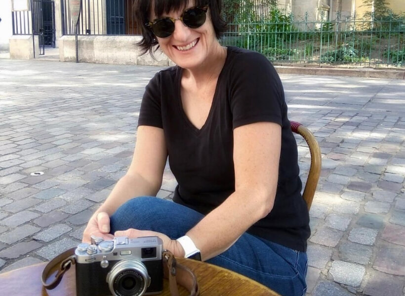 Valérie Jardin sitting at a café with her camera on the table: paris street photography episode