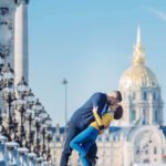 Emily and her husband kissing on the Alexander III bridge