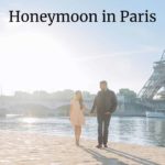 Couple walking along the Seime River with the Eiffel Tower in the background: honeymoon in Paris episode