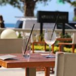 Seaside café with empty glasses on a table and the sea in the background