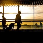 man walking through an airport: Flying to France on an Open Jaw Ticket episode