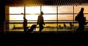 man walking through an airport: Flying to France on an Open Jaw Ticket episode