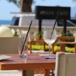 Seaside café with empty glasses on a table and the sea in the background