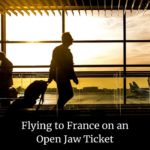 man walking through an airport: Flying to France on an Open Jaw Ticket episode