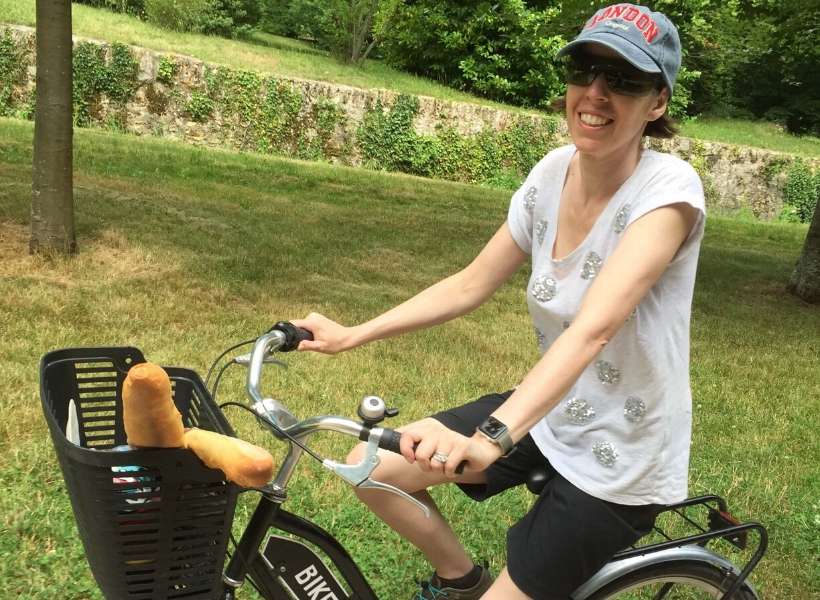 Joanne riding a bicycle in Versailles