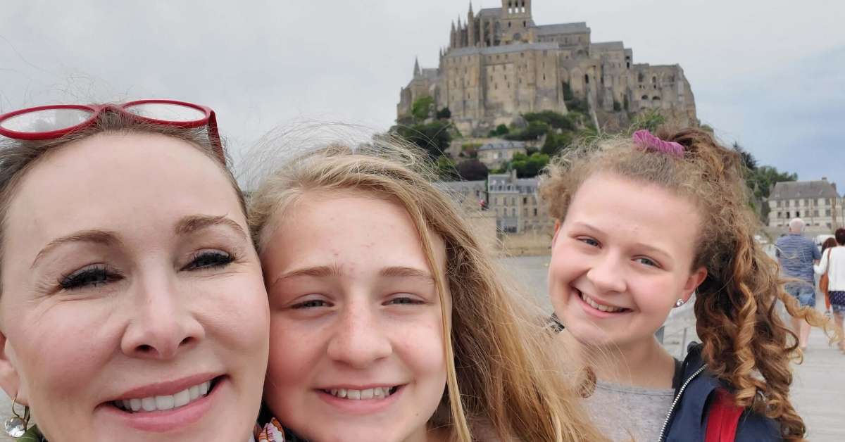Kimberly and her daughters in front of the Mont Saint Michel: Women World Cup Trip Report episode