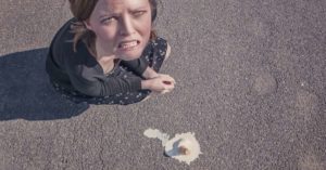 Woman looking sad that she dropped her ice cream cone: 3 common mistakes tourists make in Paris episode