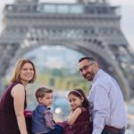 Michelle and family posing in front of the Eiffel Tower: Paris with Preschoolders episode