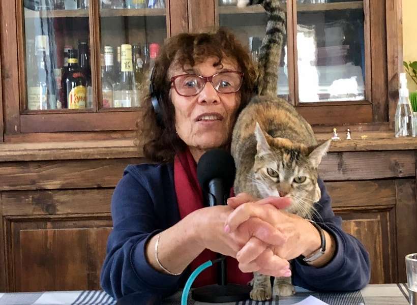 Elyse trying to talk about UNESCO World Heritage Sites in France while Annie's Cat, Ananas, pesters her