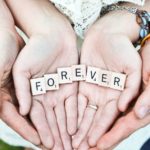 Man and woman hand-holding with the words forever written with Scrabble tiles: honeymoon in Provence episode