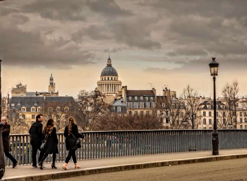 Visitors walking on a bridge in Paris: tours make a vacation better episode