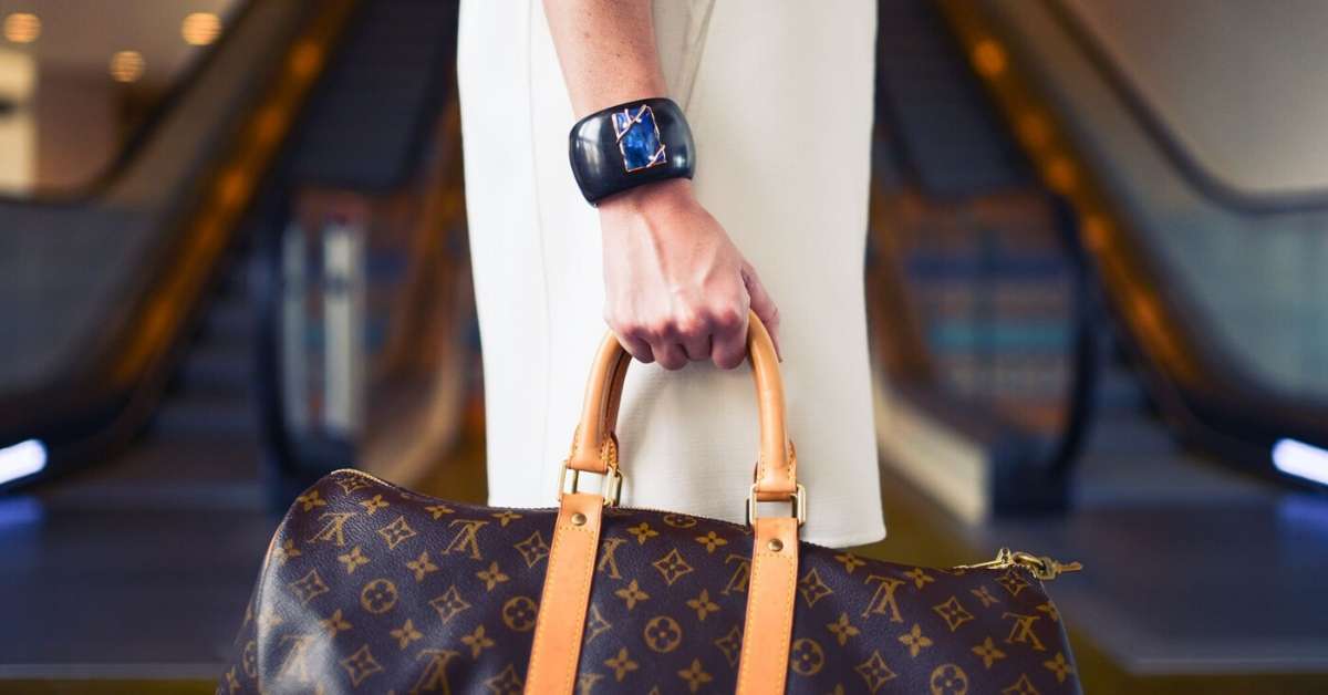 Woman carrying a Louis Vuiton bag: Haute Couture in Paris episode