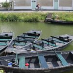 Boats tied to she side of a canal: Marais Poitevin Episode