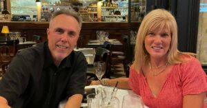Joni and Steve Goldin sitting at a restaurant in Paris: first time in Paris trip report episode