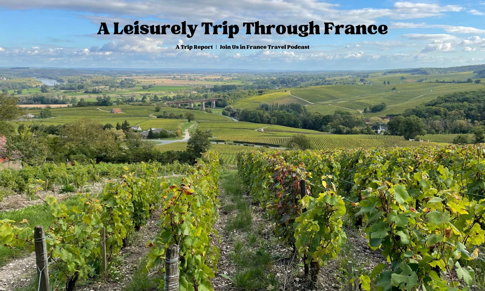 A hilly French countryside with a vineyard in the foreground: A Leisurely Trip Through France episode