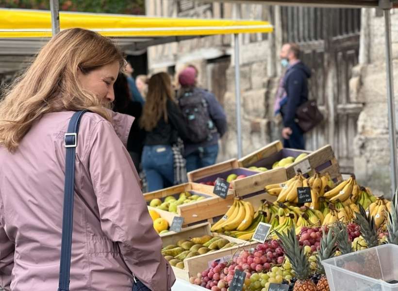 Annie Gauthier at an open-air market in France: Cruise and Pilgrimage on the Seine River episode