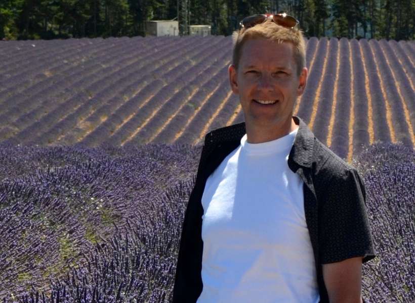 Brian Revel standing in front of a lavender field on the Plateau de Valensole