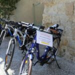 Bike rental sign in La Romieu, France. Biking trips in France newslette