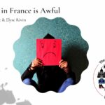 Person holding a sign with a frowny face on it: Why Life in France is Awful episode