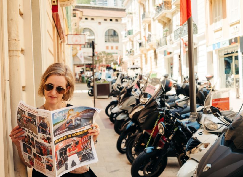 Jessica reading the paper about the Grand Prix de Monaco