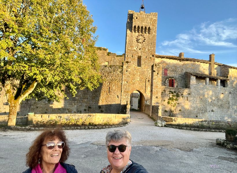 Annie and Elyse in front of the walled village of Larressingle.